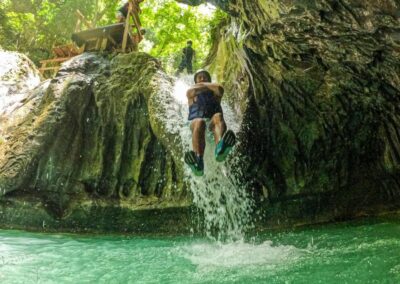 Persona con chaleco junto a una cascada de Damajagua